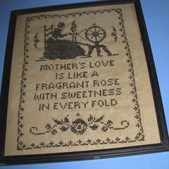 "Mother's love" cross-stitched sampler in black