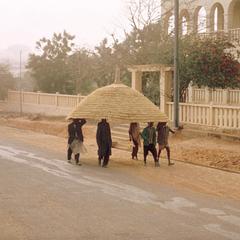 Men Carrying a Roof to a House