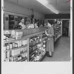 Pharmacy staff assist a customer