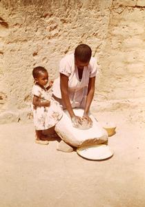 Woman Grinding Millet on a Stone in Central Tanzania
