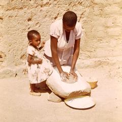Woman Grinding Millet on a Stone in Central Tanzania