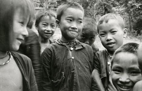 A group of Blue Hmong (Hmong Njua) children pose for a photograph in a Hmong village in the vicinity of Muang Vang Vieng in Vientiane Province