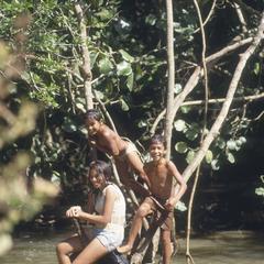 "Muco" children swimming and woman washing in stream