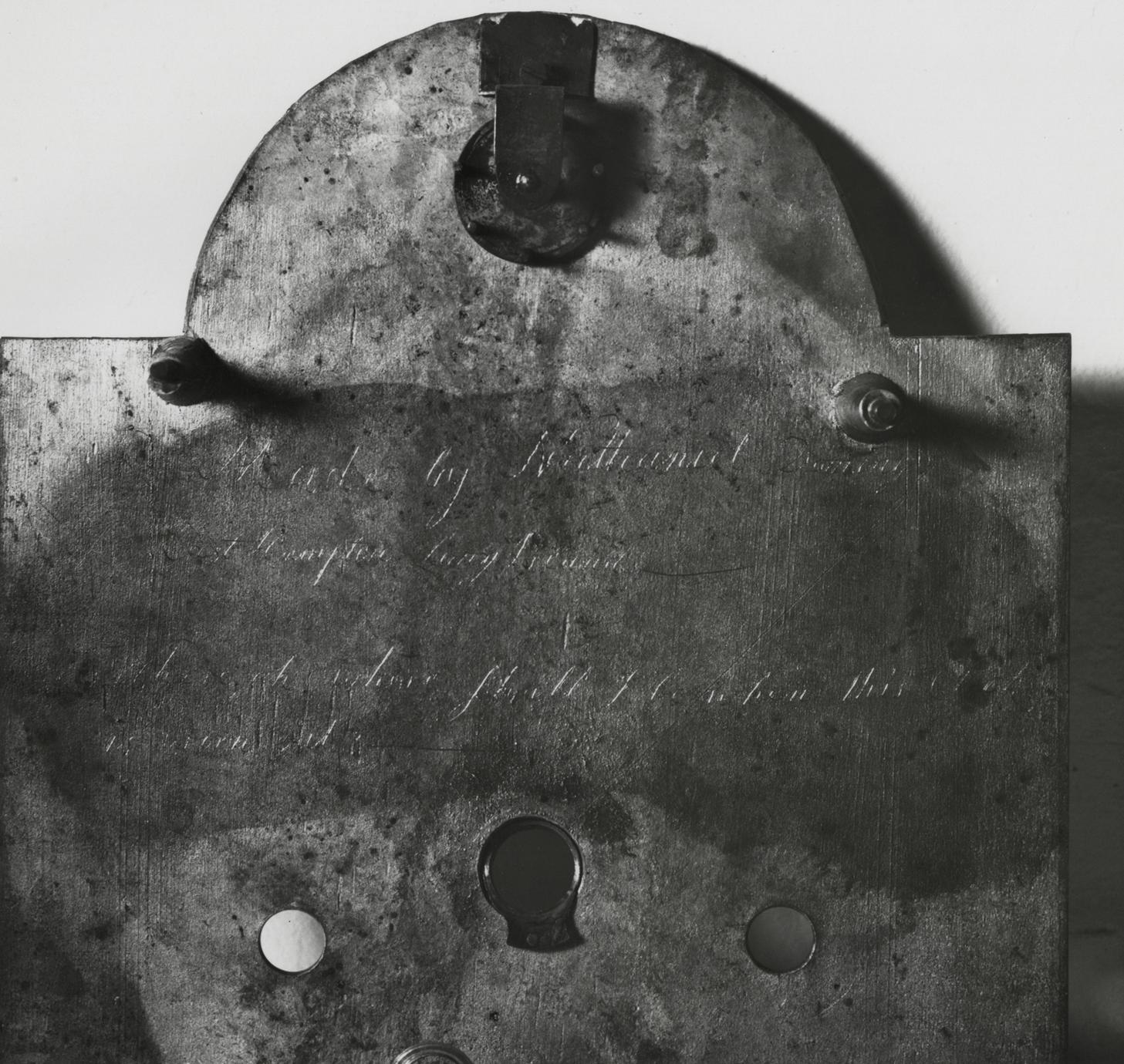 Black and white photograph of the inscription on the back of an eight-day, strike, repeater, alarm clock.