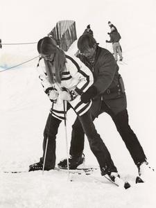 Professor Tom Brigham helping a student during ski class