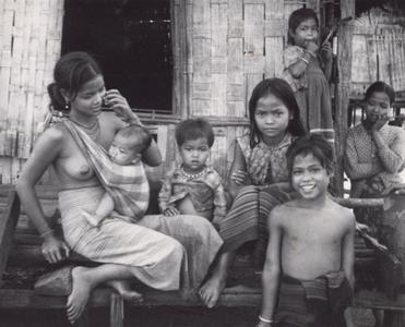 Nyaheun mother with baby and several children surrounding her in Houei Kong Cluster in Attapu Province
