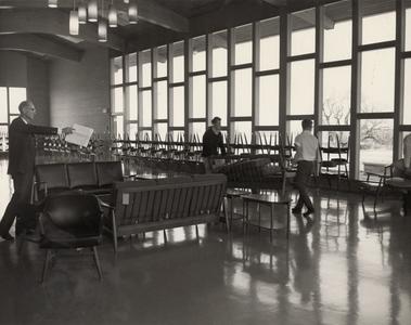 Students moving furniture in student lounge, Manitowoc, spring 1966