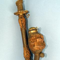 Object 1 titled "Pipe of wood, antler, and brass with deer imagery."