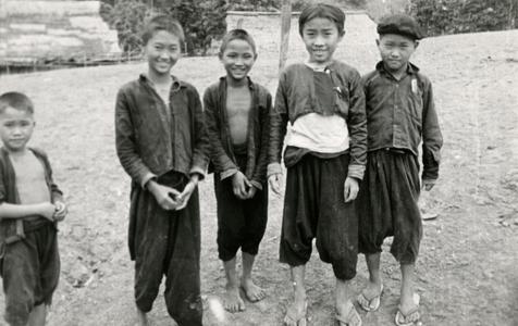 Five Blue Hmong (Hmong Njua) boys stand in a Hmong village near Muang Vang Vieng in Vientiane Province