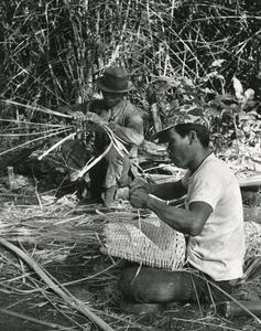 Villagers weaving bamboo to make fish baskets in Attapu Province