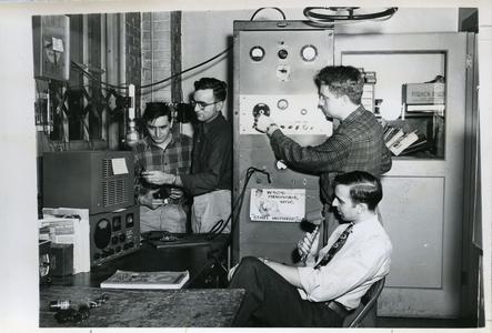 Radio Club members working on the machine and talking into the radio microphone