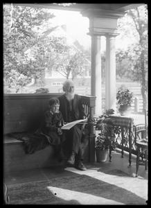 F. W. Lyman and granddaughter Elizabeth on porch