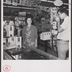 A woman poses for a photograph in a drugstore