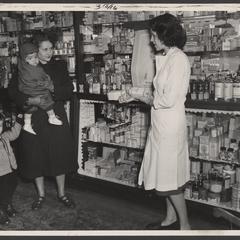 A woman speaks to a pharmacist about baby products