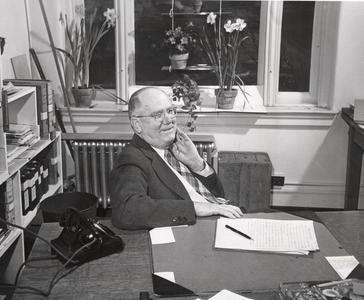 James G. Moore at his desk