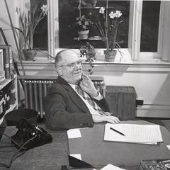 James G. Moore at his desk