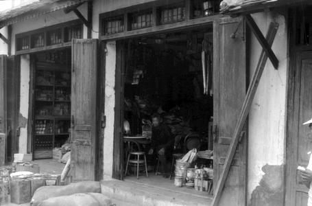 Chinese stores with sacks of rice, cooking oil, and pots