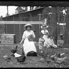 Women and children with chickens