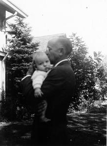 Aldo Leopold holding a baby