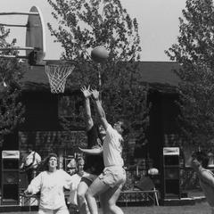 Students playing basketball near student housing