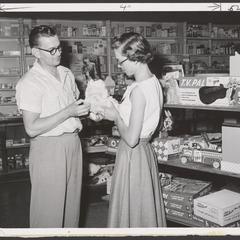 A salesman assists a customer in the toy department