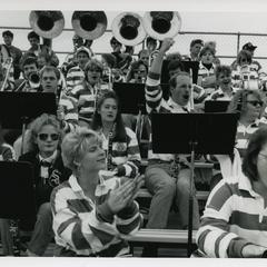 Pep band cheering in the stands at Homecoming football game