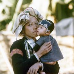 A Yellow Lahu (Lahu Shi) mother holds her infant in Houa Khong Province