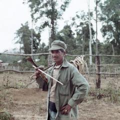 Nyaheun villager returns from his highland field carrying a supply of rattan in Attapu Province
