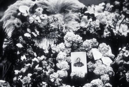 Close-up of floral memorial and photo of deceased