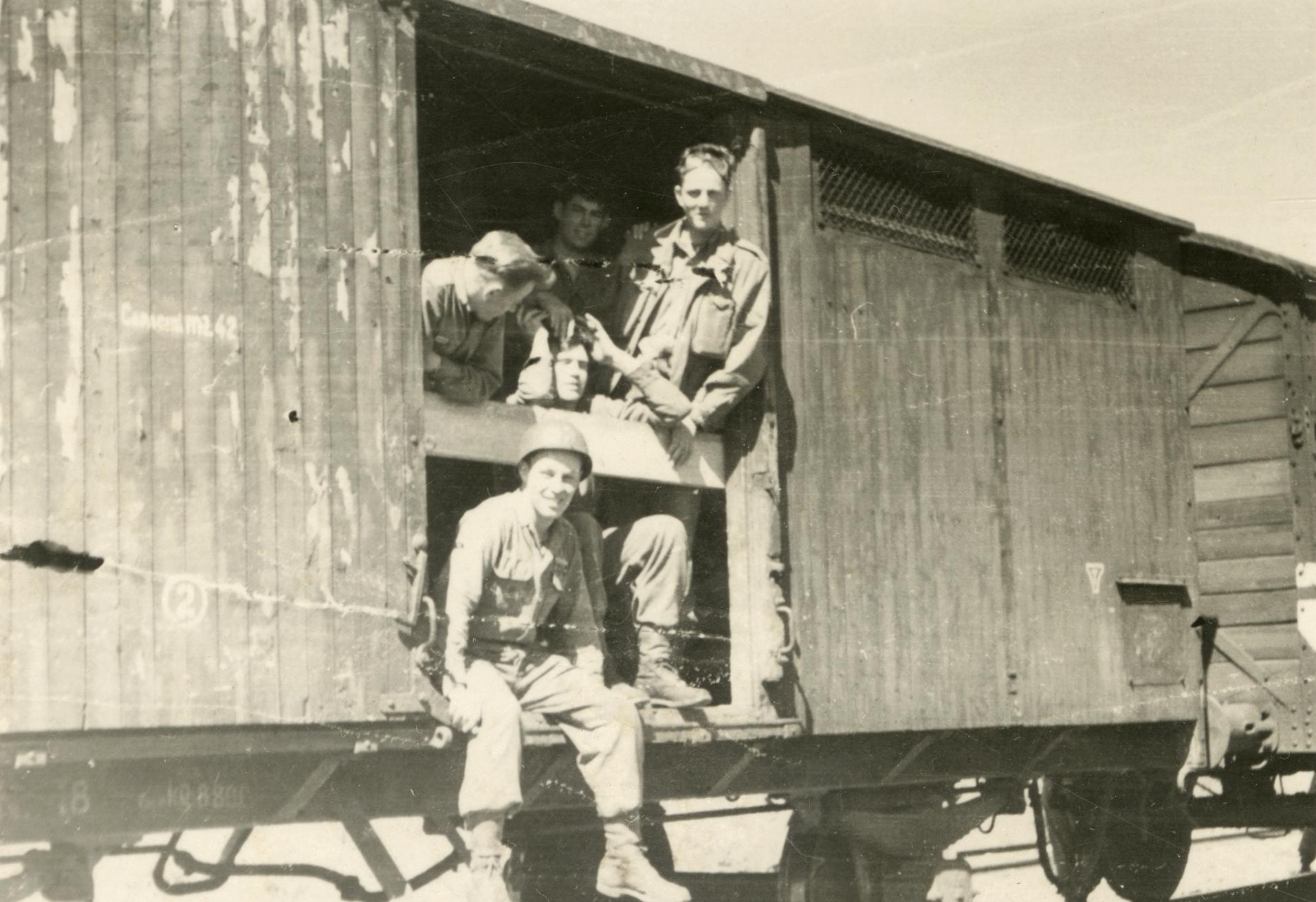 Ray Cunneen sitting in the doorway of the box car