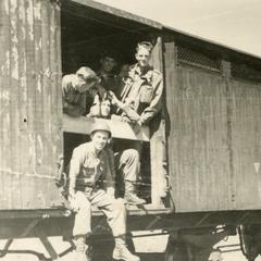 Ray Cunneen sitting in the doorway of the box car