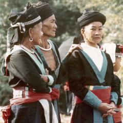 Three White Hmong women stand in the village of Nam Phet in Houa Khong Province