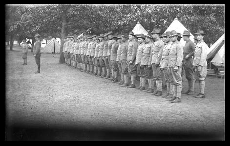 Soldiers in formation, military tent camp