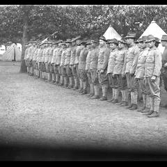 Soldiers in formation, military tent camp