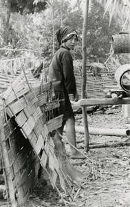 Akha woman preparing bamboo mats in the village of Phate in Houa Khong Province