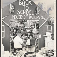 Shoppers select items from a back-to-school display