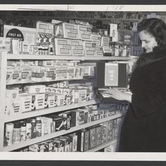 Woman looks at first aid kit in drugstore
