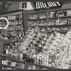 A salesclerk works the vitamin counter in a drugstore