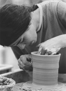 Student working on potter's wheel