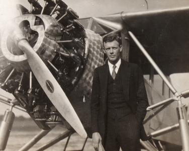 Lindbergh standing by his plane