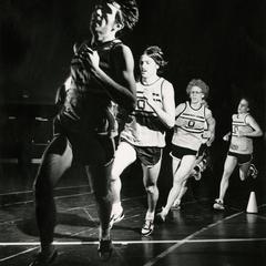 Men running around indoor track