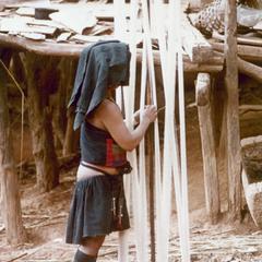 An Akha woman prepares threads for weaving in the village of Sobloi in Houa Khong Province