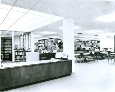 Students at front desk of the library
