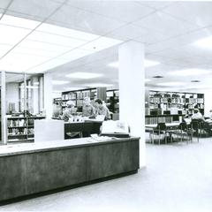 Students at front desk of the library