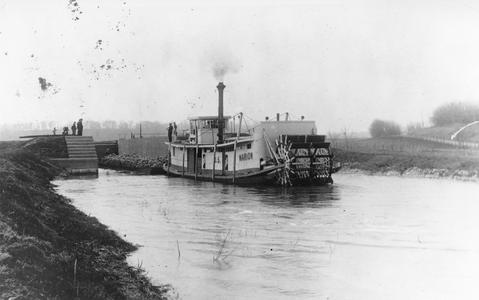 Stern view of the Marion with tow in canal