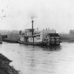 Stern view of the Marion with tow in canal