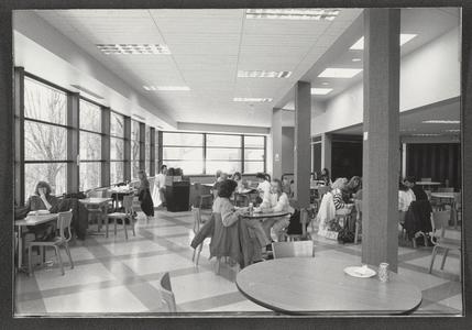 Multiple students studying and eating in the cafeteria
