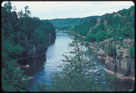 View of a river with cliffs in a northern forest