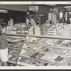 A young girl selects candy at a candy counter
