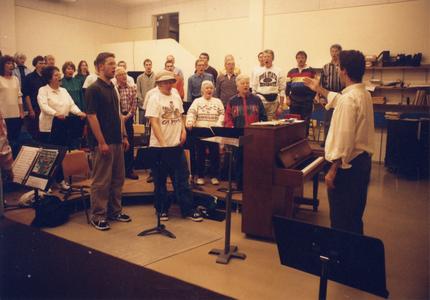 Music professor Peter Gibeau leading a chorus